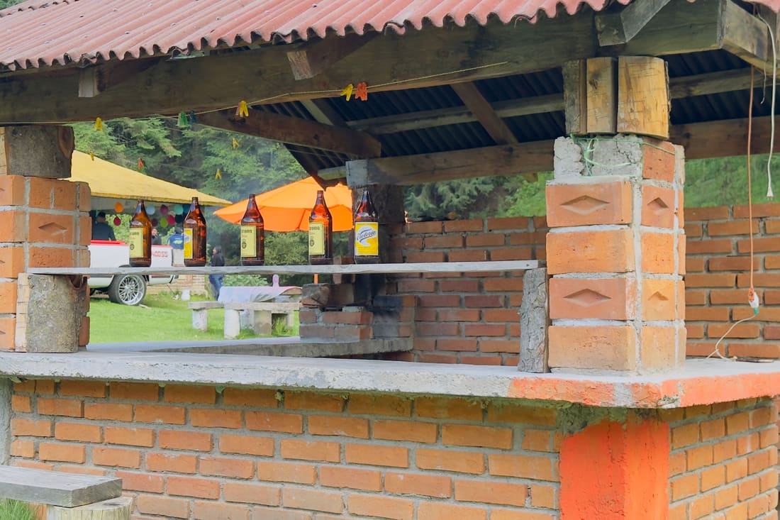 Asador de ladrillo techado en el pasto